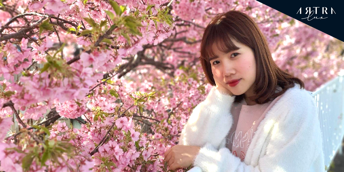 a lady takes a picture with Sakura